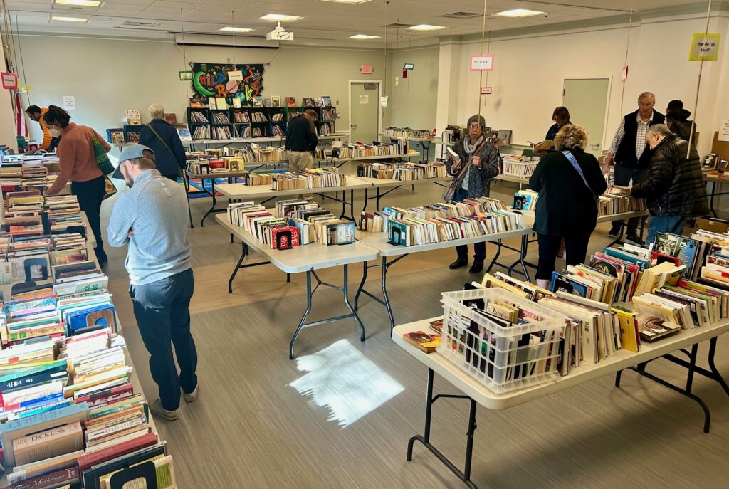 Neighbors shop the used book sale. 